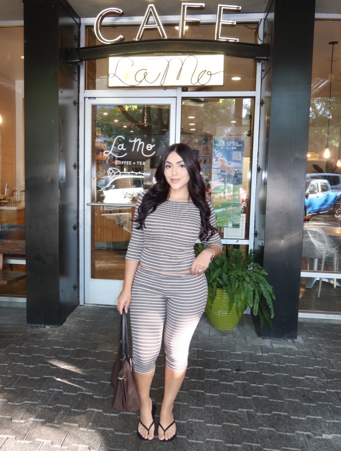 Front view of a model wearing a stretchy micro-ribbed capri set