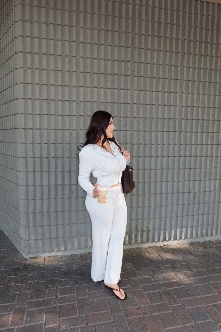 Front view of a white long-sleeve zip-front two-piece set